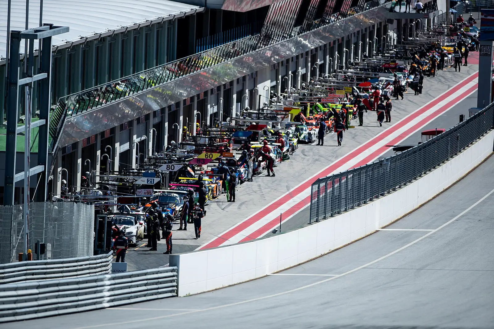 Pit lane and paddock with cars lined up at the Red Bull Ring in Spielberg