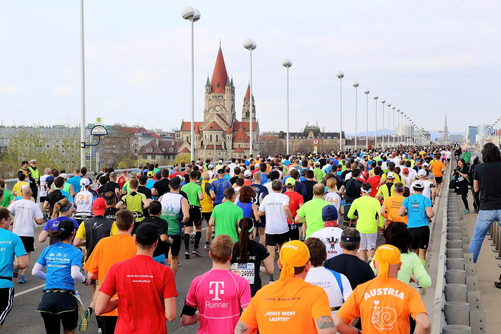 Large field of runners crossing the Reichsbruecke bridge in the Vienna City Marathon 2015
